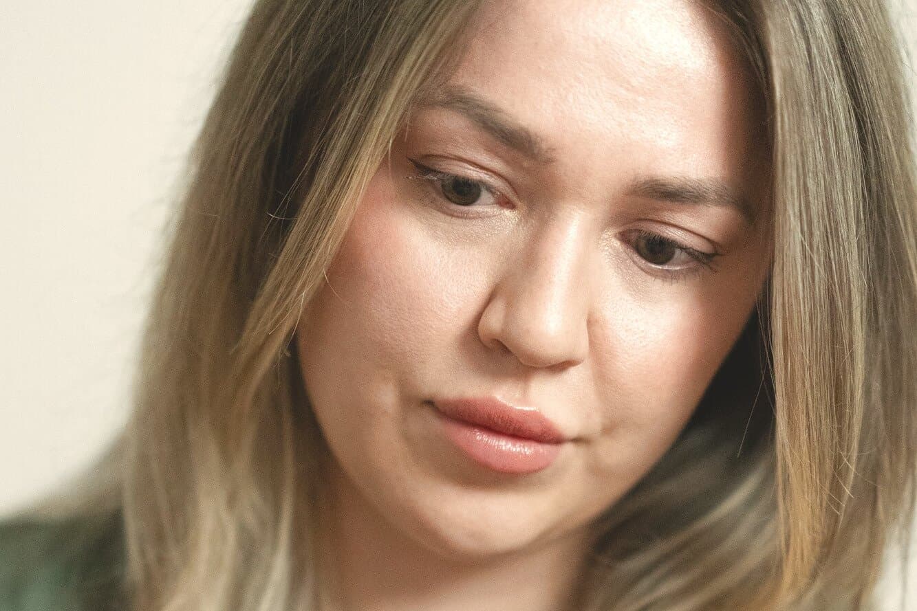 A provider leaning in to look closely at a guest's face